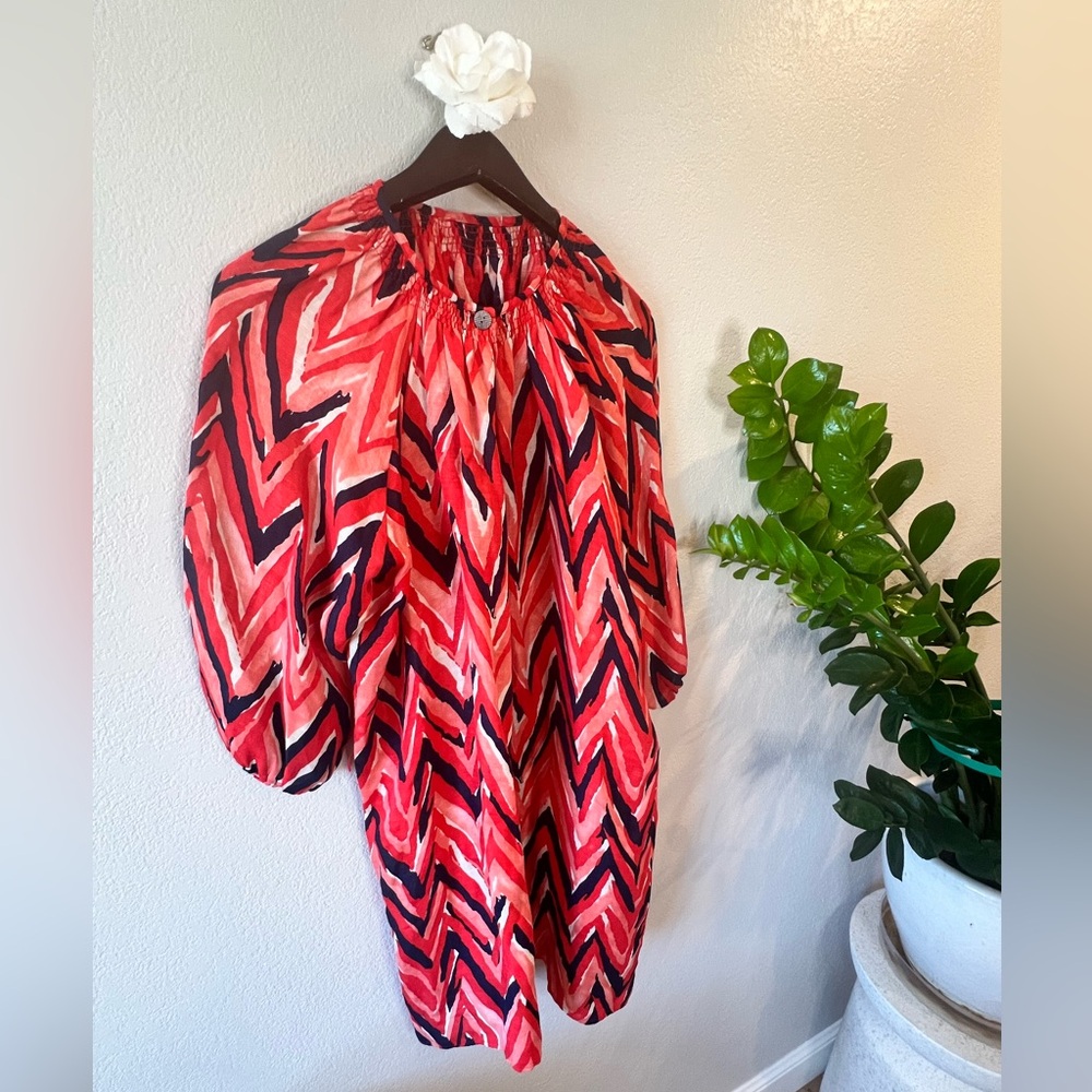 A relaxed midi dress coverup, vibrant print, with an A-line silhouette